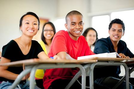 high school students sitting at desks in classroom