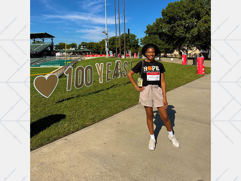 Jasmine Hutchison posing outside near a sports field