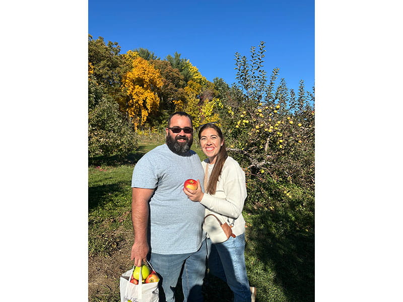 John and Kayla Messana picking apples in 2024