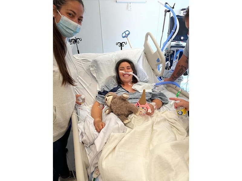 Kayla Messana smiling in her hospital room after recently waking up from a coma